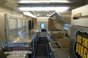 food truck interior with fryers, grill and service window