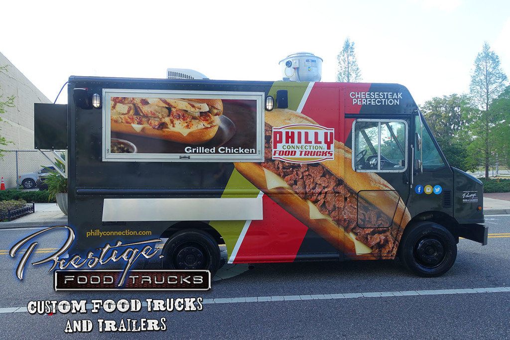 side view of black, red and gold food truck with image of a philly cheesesteak sandwich