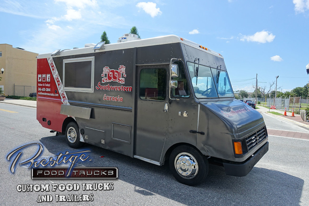 gray and red food truck side view in parking lot