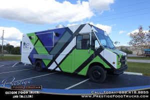 food truck exterior showing closed service window and colorful geometric graphics wrap