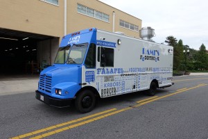 blue and gray food truck parked in front of a building