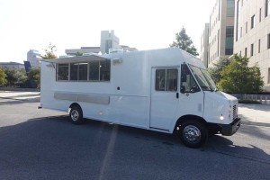 side view of white food truck with service window open