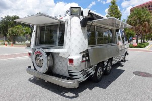 side and rear view of retro food truck with side and rear service windows open