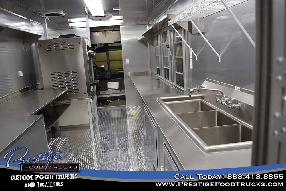 food truck interior with sinks, shelving and service window