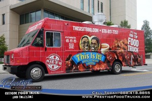 side view of red food truck with bbq food images