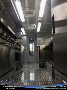 photo of food truck interior down the center aisle with appliances on either side