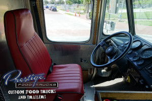 photo of a food truck interior showing the driver's seat and steering wheel