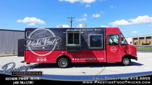 exterior of Vicki Vail's black and red food truck, viewed from the side with open service window
