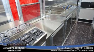 food truck interior with sink, service window and food prep table
