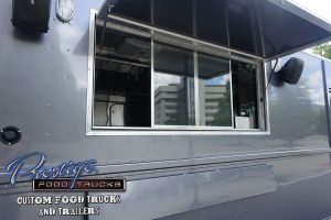 close up of gray food truck service window open to reveal inside