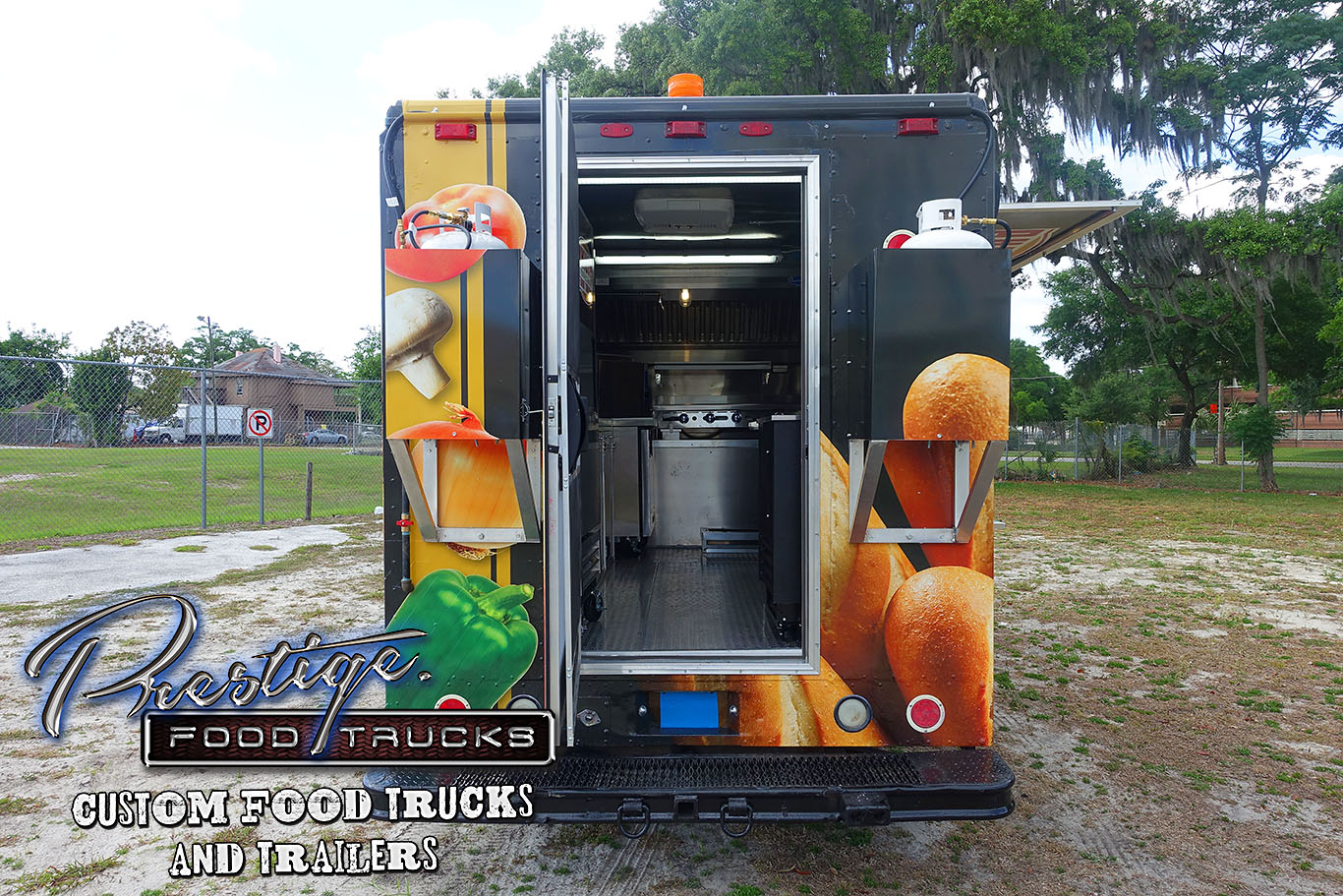 rear view of black food truck with rear door open to reveal inside kitchen