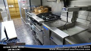 food truck interior with oven and stovetop, warming tray and fryers