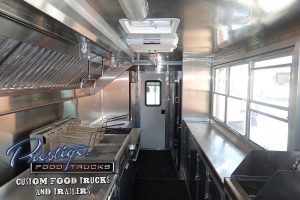 food truck interior showing service window, fryers and back door