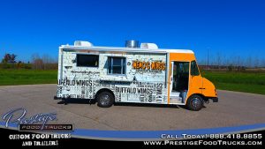 wemo's wings food truck with white and orange graphics