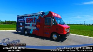 cafe food truck with service window and blue and red graphics