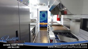 food truck interior with fridges, grill and exhaust hood