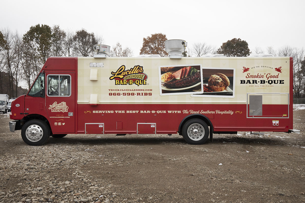 driver side photo of a red and cream colored food truck