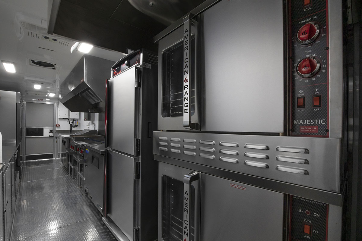 food truck interior kitchen photo showing ovens, proofing cabinet and griddle