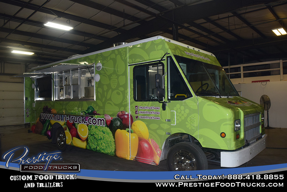 green food truck inside a warehouse