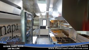 interior of a food truck showing fridge and stove