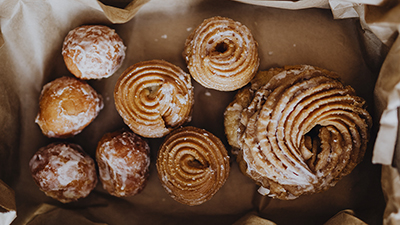 top down view of assorted pastries on a tray lined with brown paper