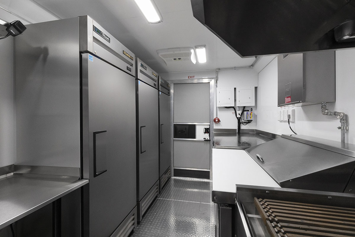 food truck interior kitchen photo showing fridge and sandwich prep table