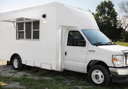 white cutaway food van parked on grass