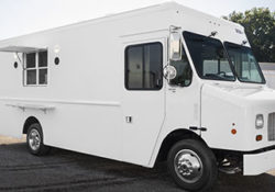 photo of a white food truck sitting outside