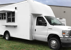 small white food truck with open serving windows